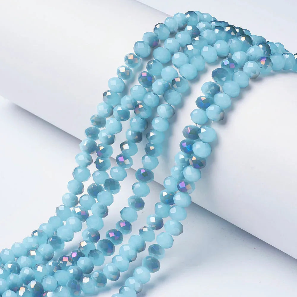 Facetterade glaspärlor - Halvopak Ljusblå med oljeshimmer, 6x5mm 1 sträng Hilmas Pyssel