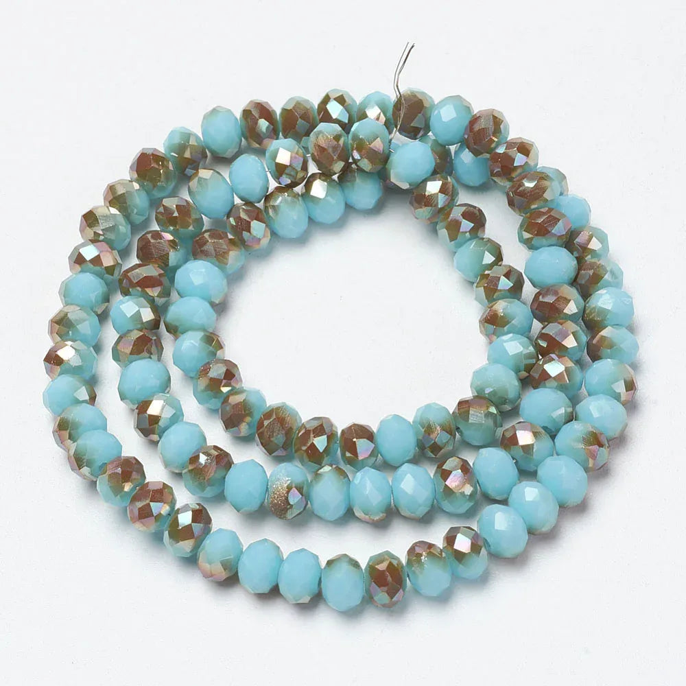 Facetterade glaspärlor - Turkos med regnbågsshimmer 8x6mm 1 sträng Hilmas Pyssel