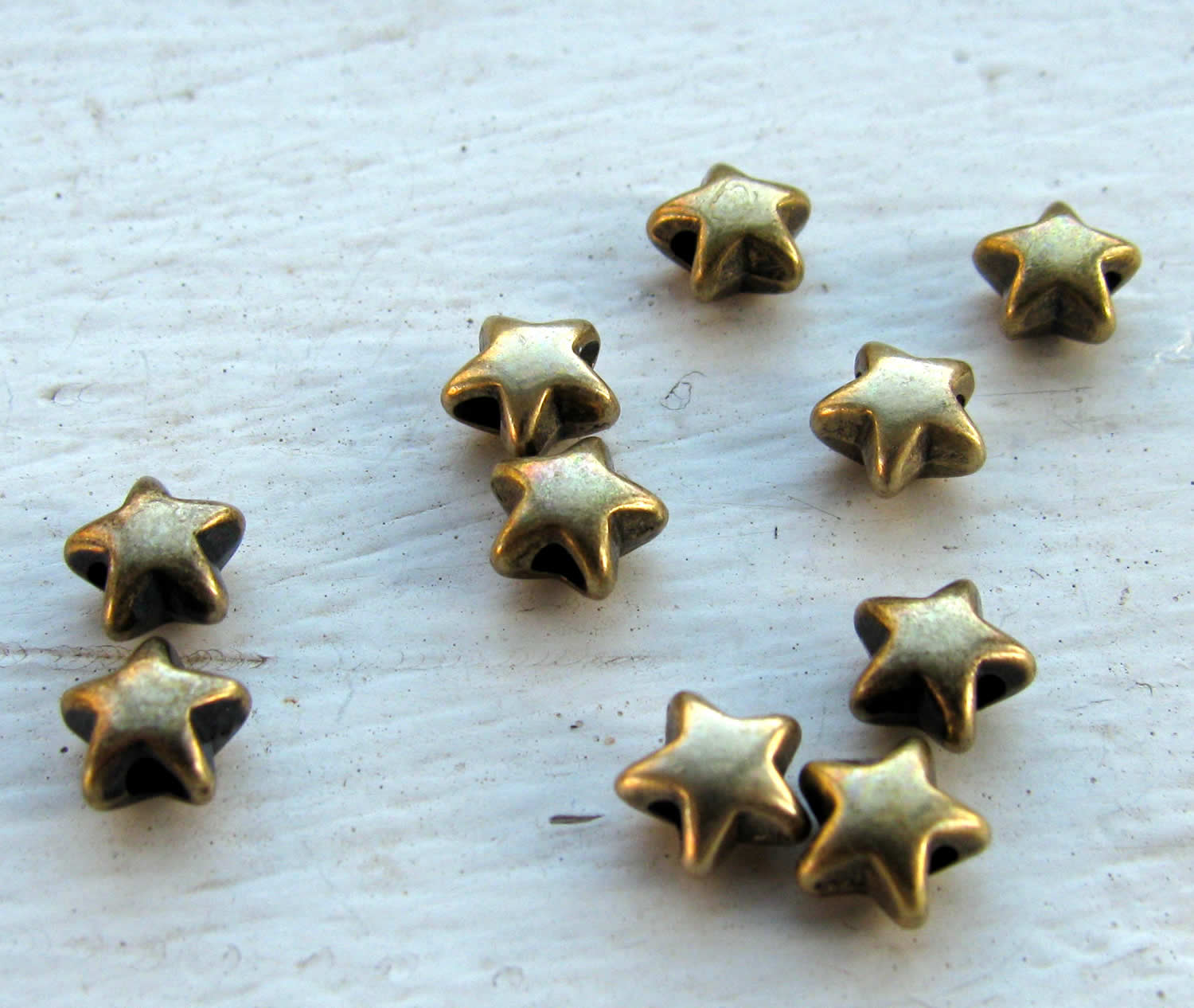 Mellandel bronsfärgad - Liten stjärna, 6mm, 10-pack Grekisk Metall