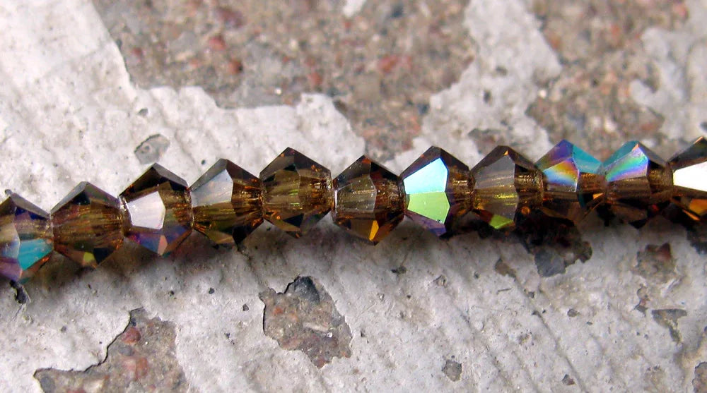 Tjeckiska MC Bicone - Smokey Topaz AB 3 mm, 40- pack Preciosa